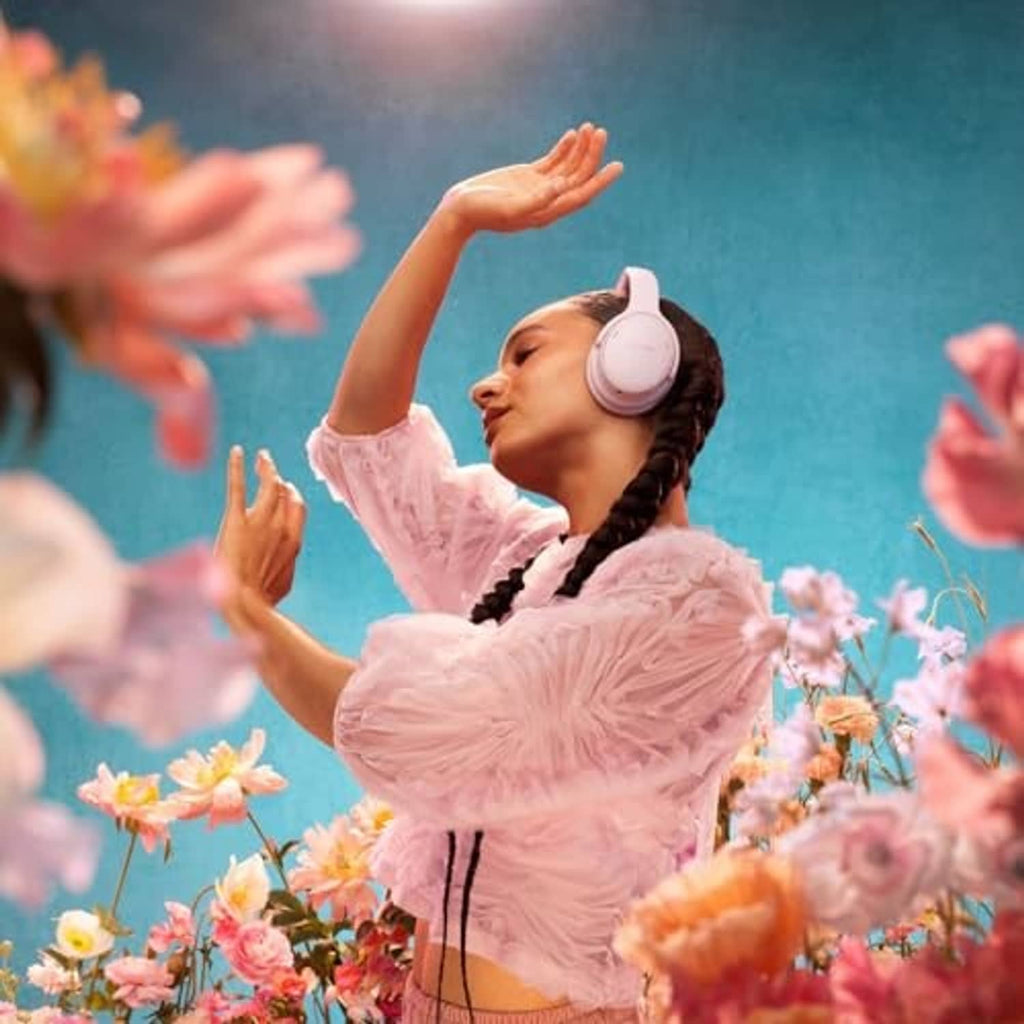 Pink wireless over-ear headphones worn on a person's head