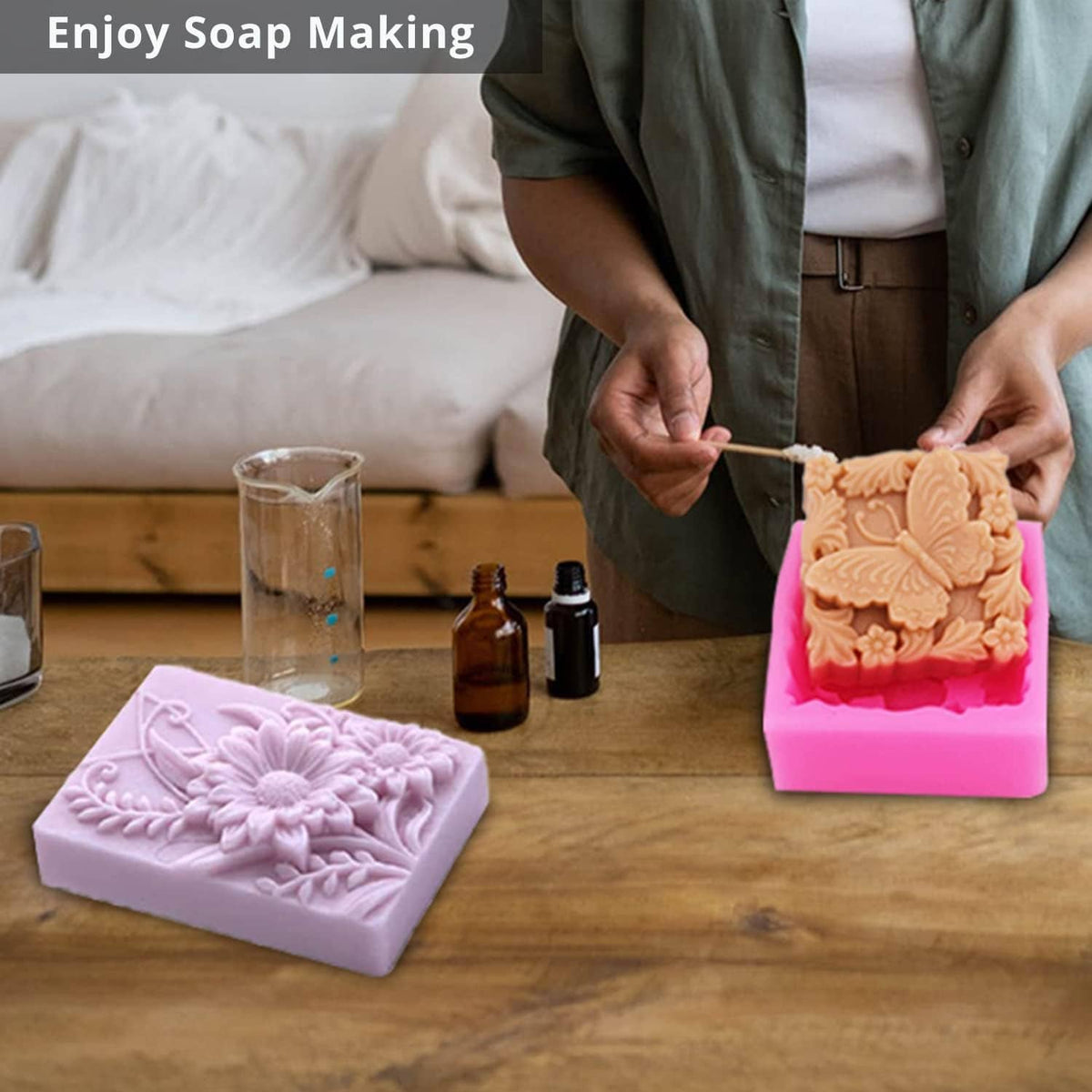 Person filling a pink silicone soap mold with 3D floral butterfly embossed design