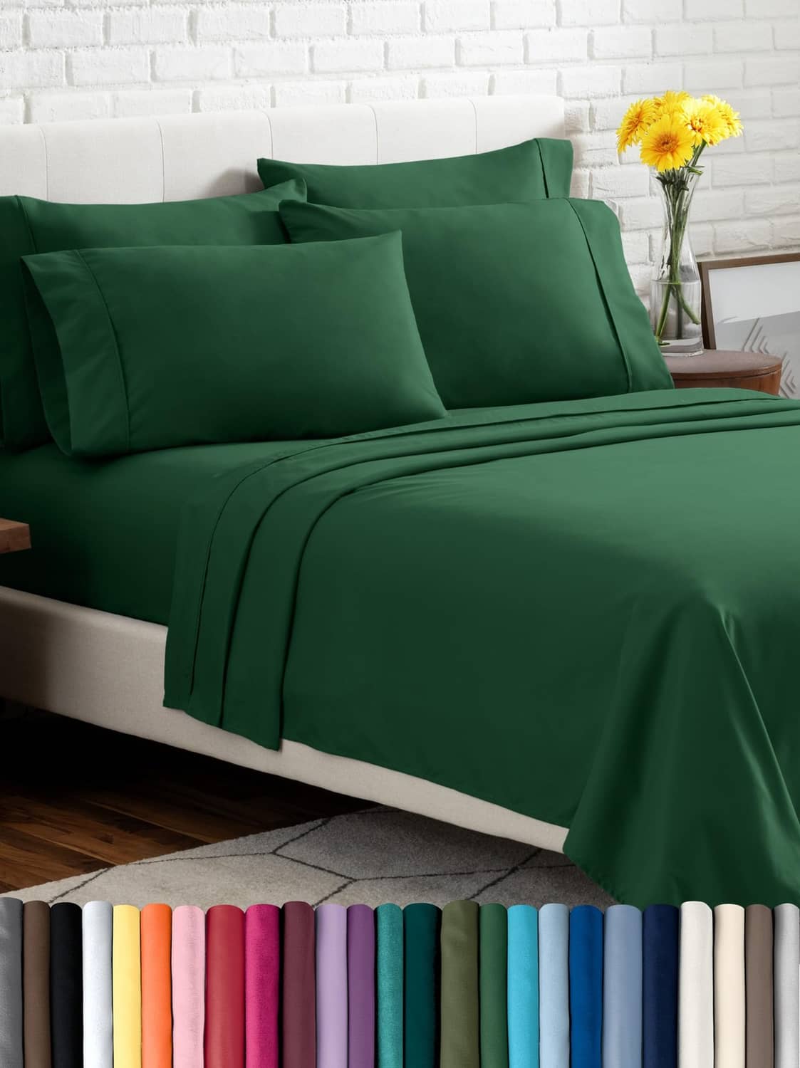 Forest green bed sheet set with two pillowcases and flat sheet neatly laid out