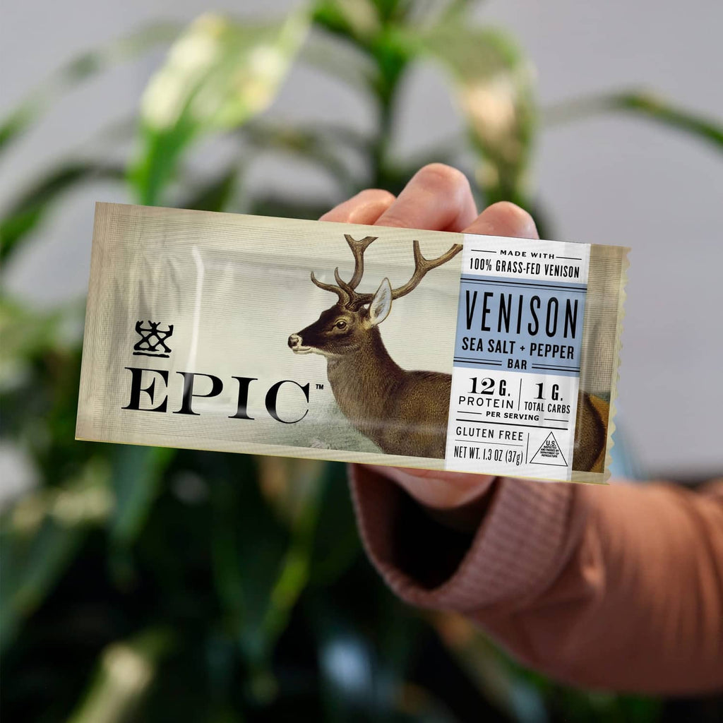 Hand holding an Epic Venison Sea Salt + Pepper Bar packet