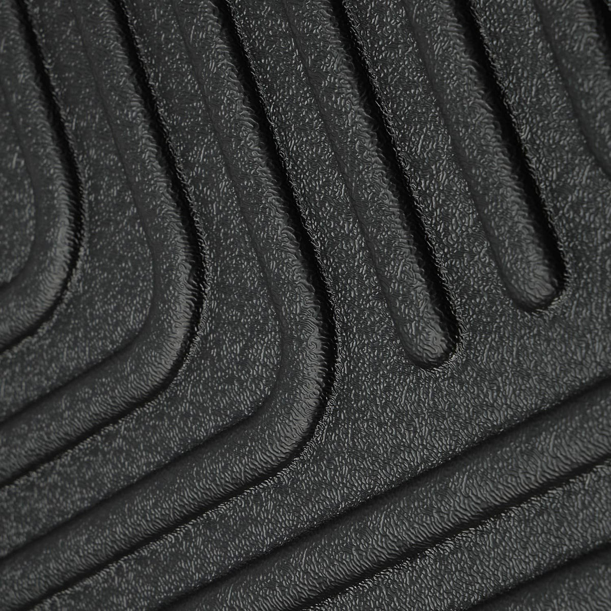 Close-up of black rubber floor mat with textured grip ridges