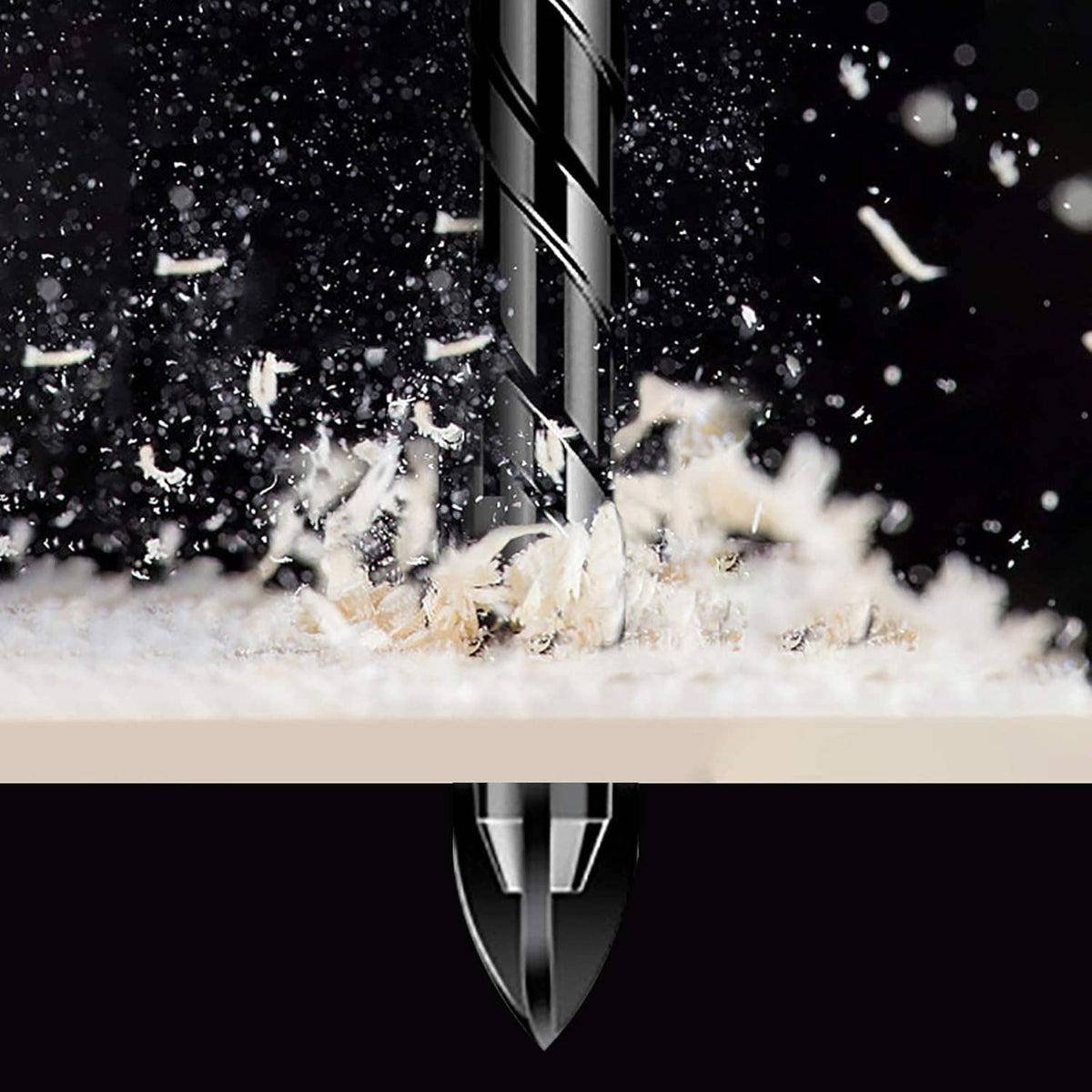 Masonry drill bit drilling into surface with visible dust and debris at the tip