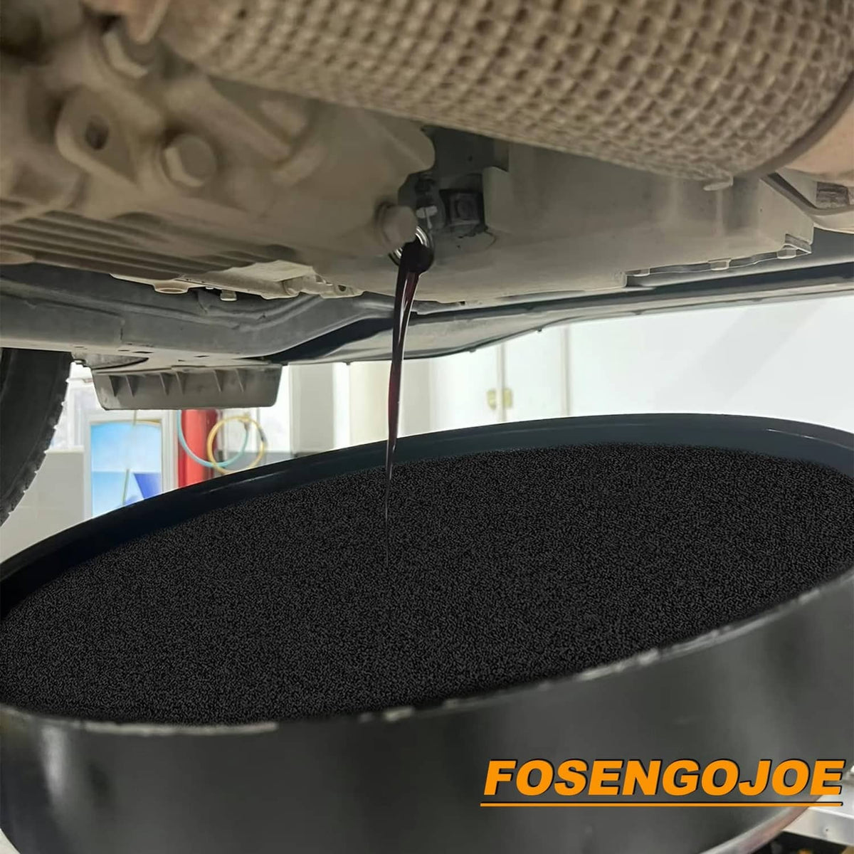 Black round oil drain pad catching dripping oil during change