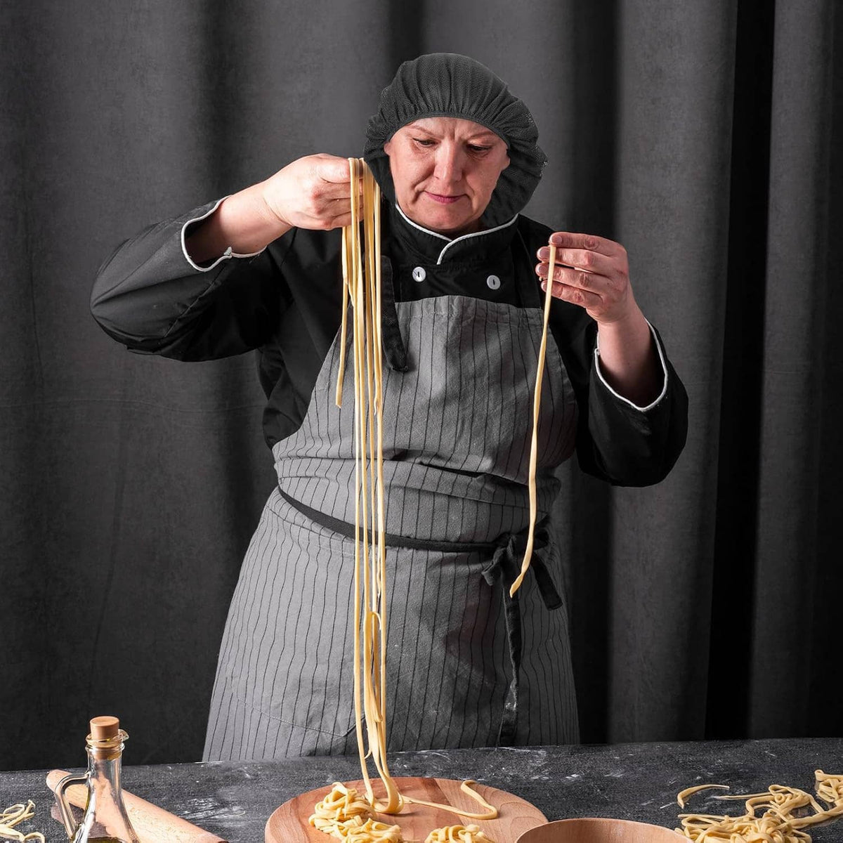 Black chef hairnet cap with elastic band on chef preparing food
