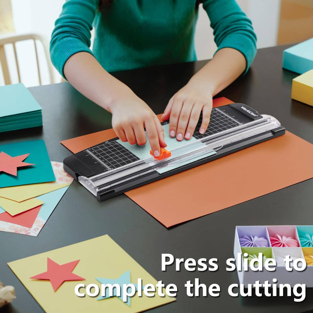 WorkLion paper trimmer in use with sliding cutter and metal rails over paper