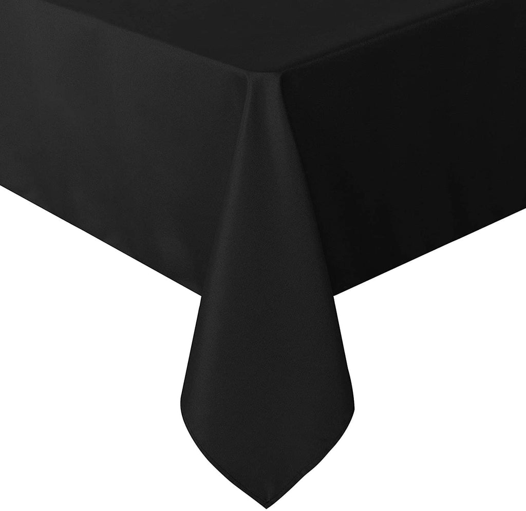 Rectangle tablecloth, dark color, close view of corner fold and hanging skirt edge.