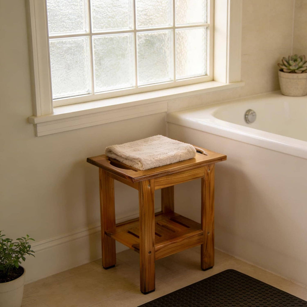 Teak slatted shower stool with lower shelf, holding a folded towel