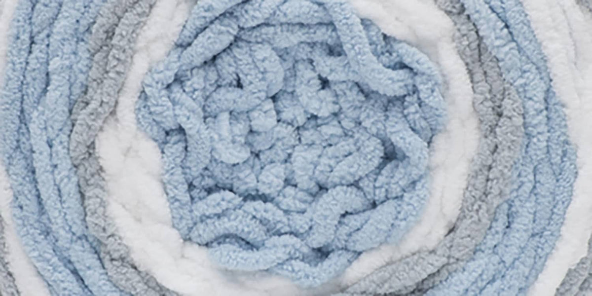 Super bulky dappled knit baby blanket with light blue and white stripe texture