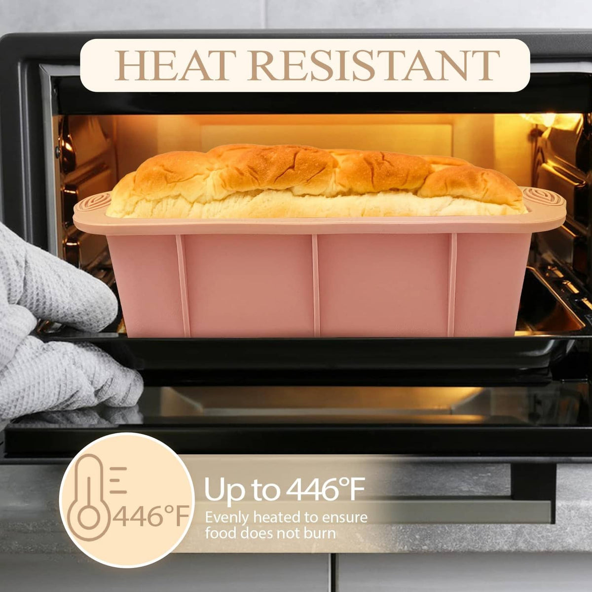 Pink silicone loaf pan with baked bread inside an oven