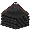 Black shade cloth mesh tarp, folded with two reinforced grommets at the corner