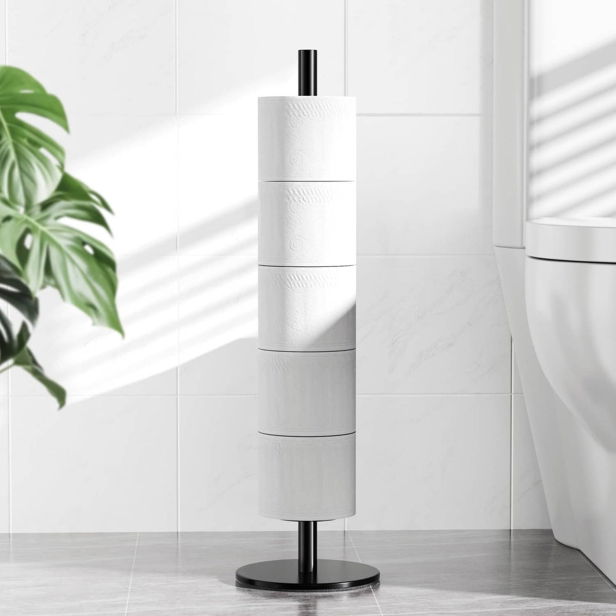 Matte black toilet paper stand with vertical post and round base holding a roll