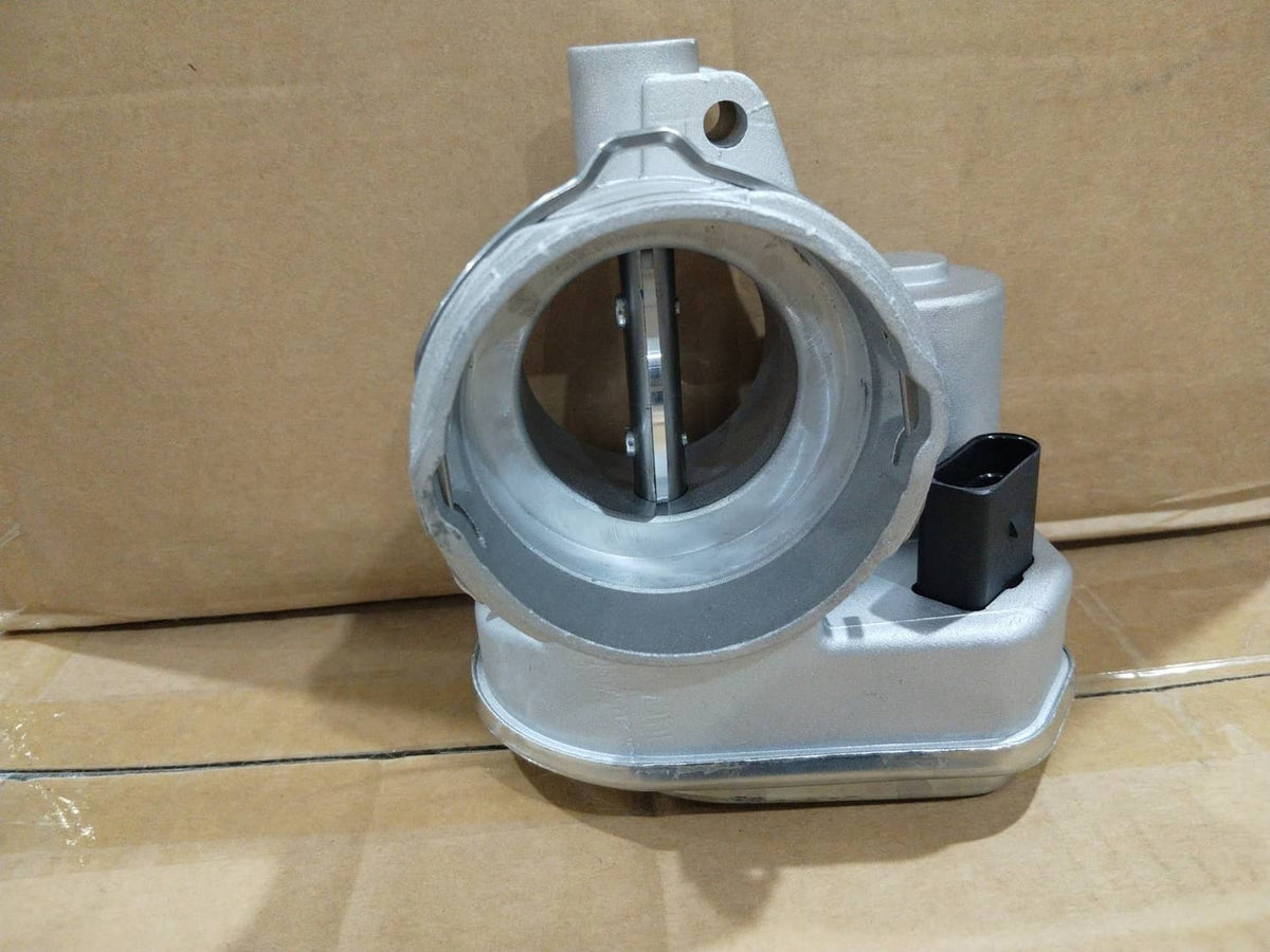 Silver throttle body with circular intake opening and vertical valve shaft