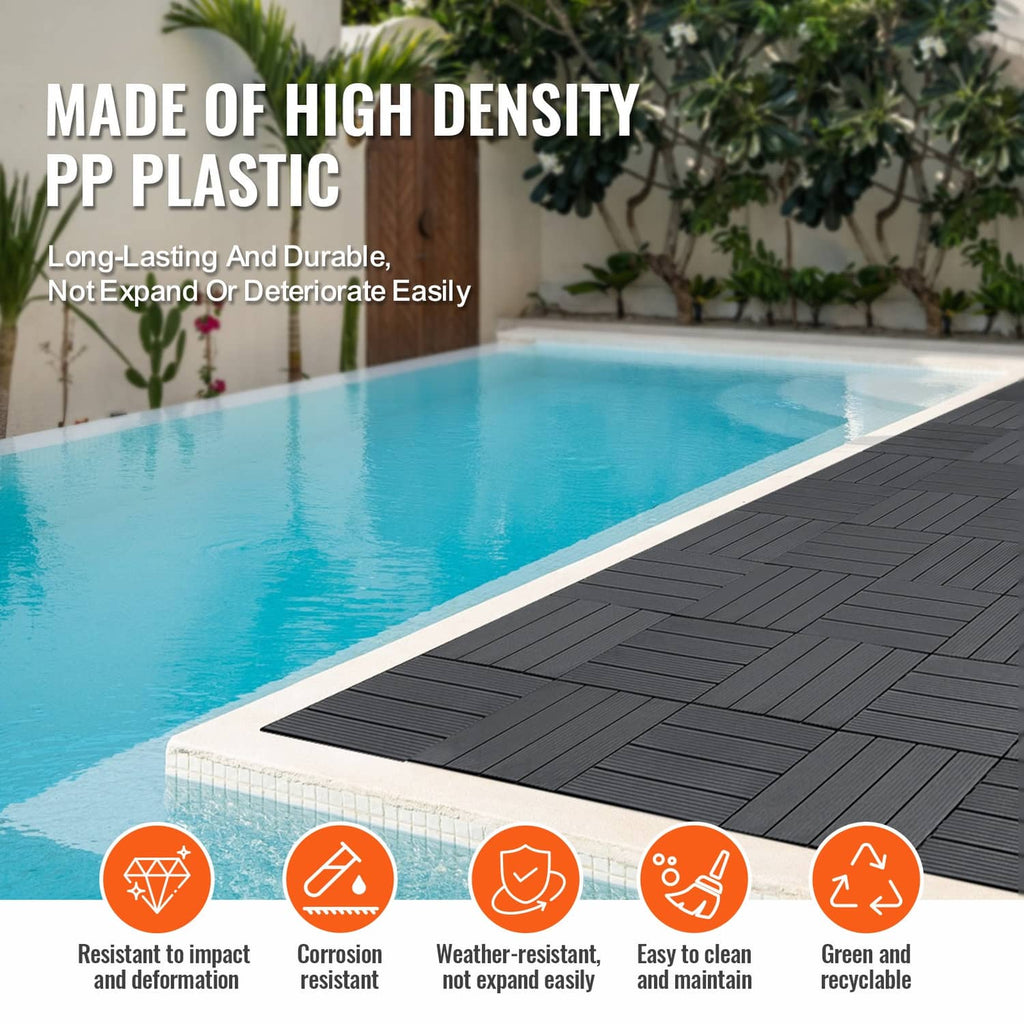 Dark grey plastic interlocking deck tiles with ribbed surface along poolside