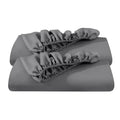 Grey fitted sheet set folded with gathered elastic edges