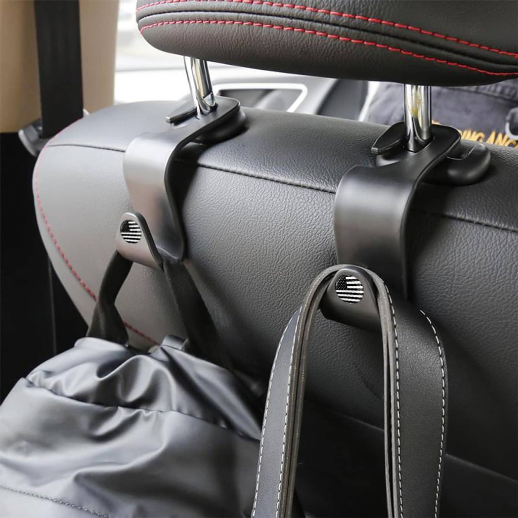 Black headrest hook on dark leather seat with arched hanger and ridged knob