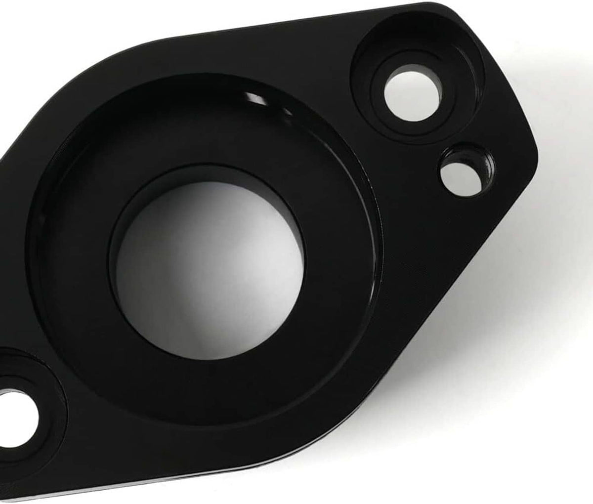 Close-up of black blow off valve adapter ring opening with mounting holes on plate