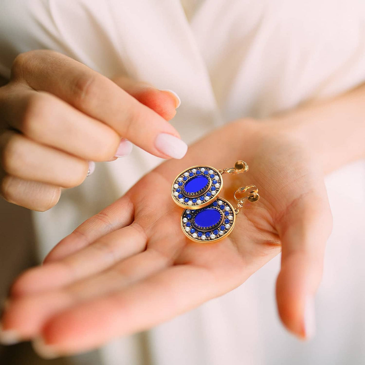 Blue enamel oval drop clip-on earrings with rhinestone edges in gold-tone