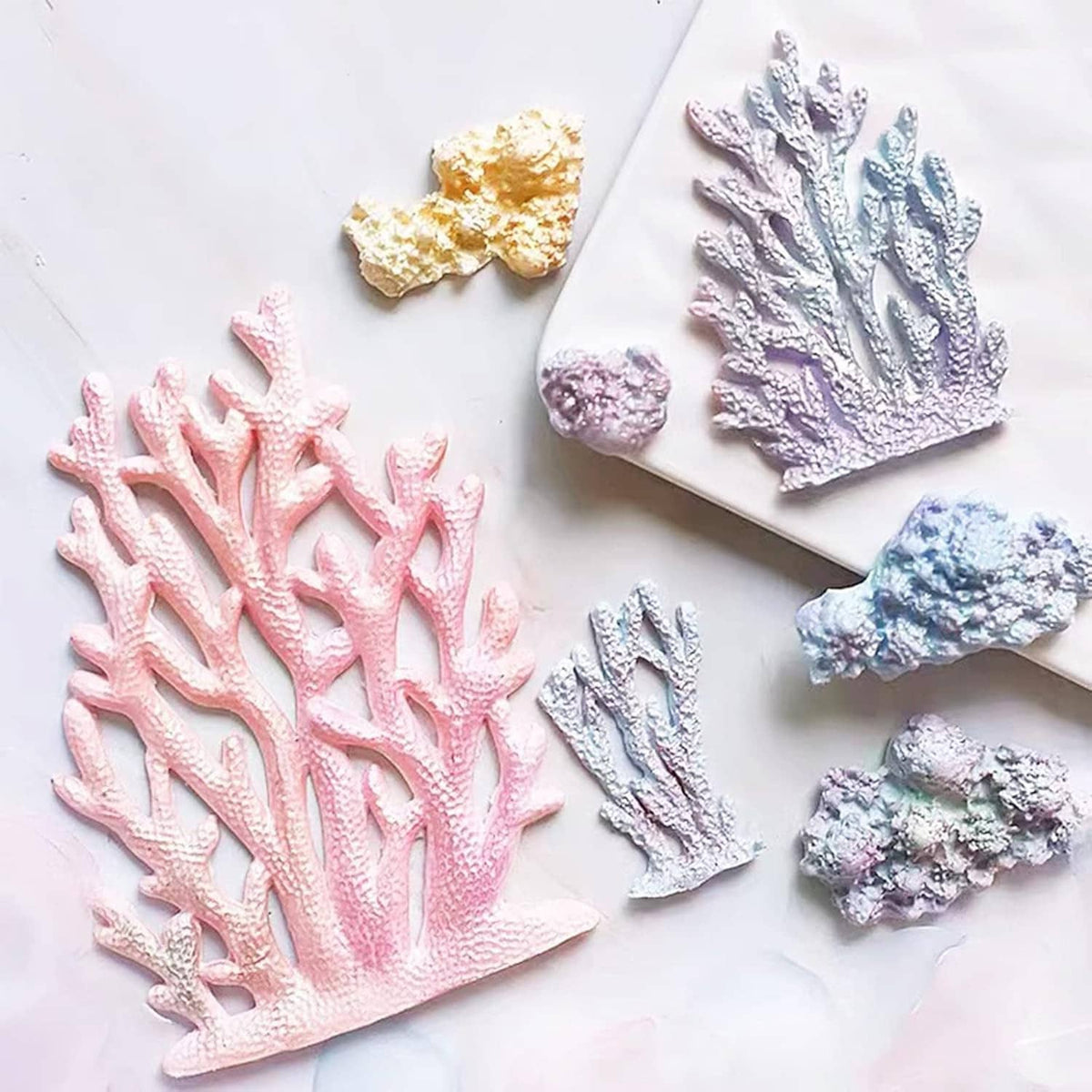Marine-themed silicone mold set with pink, blue, purple seaweed, fish, coral, and turtle shapes