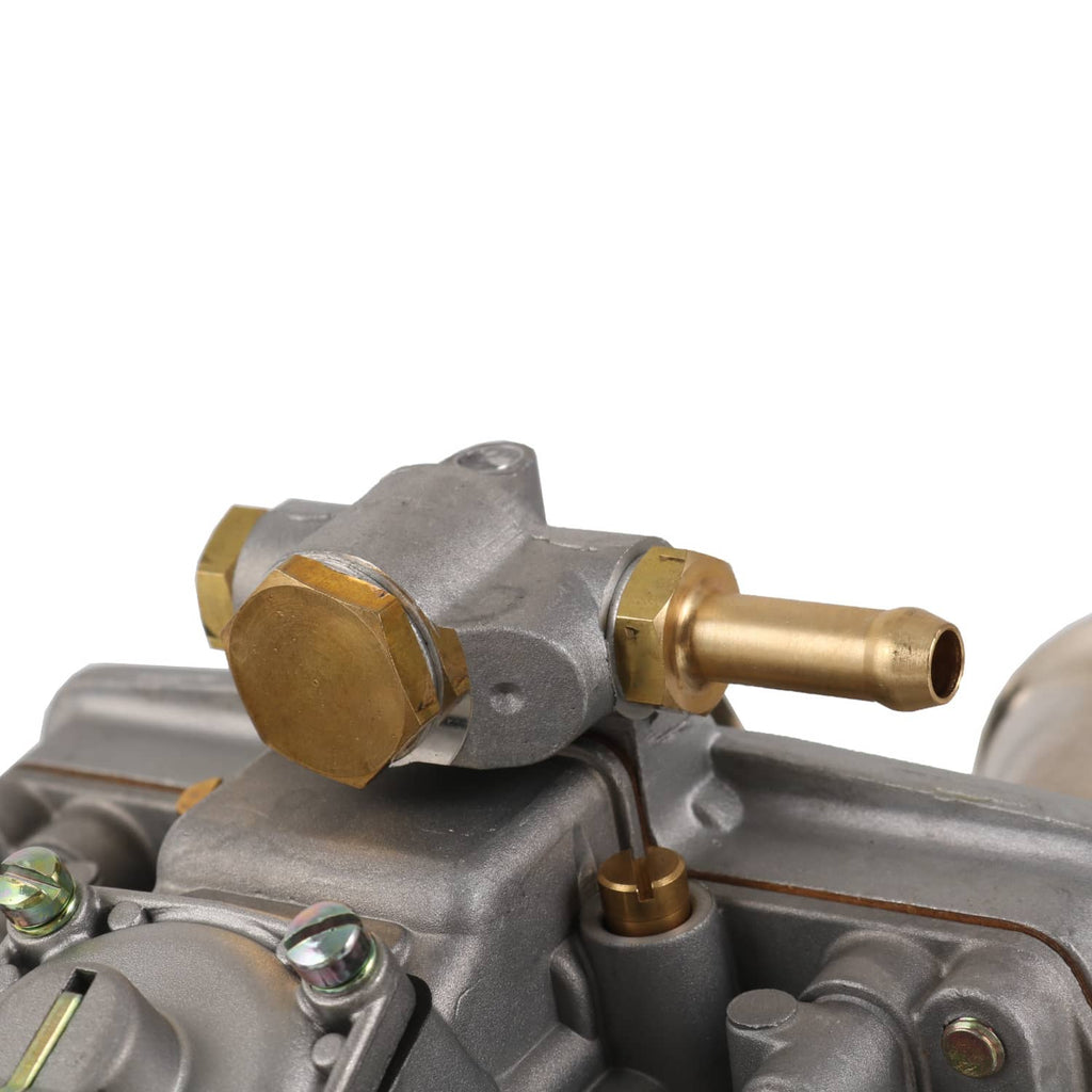 Close-up of carburetor casting with brass fittings and small sensor-style connector