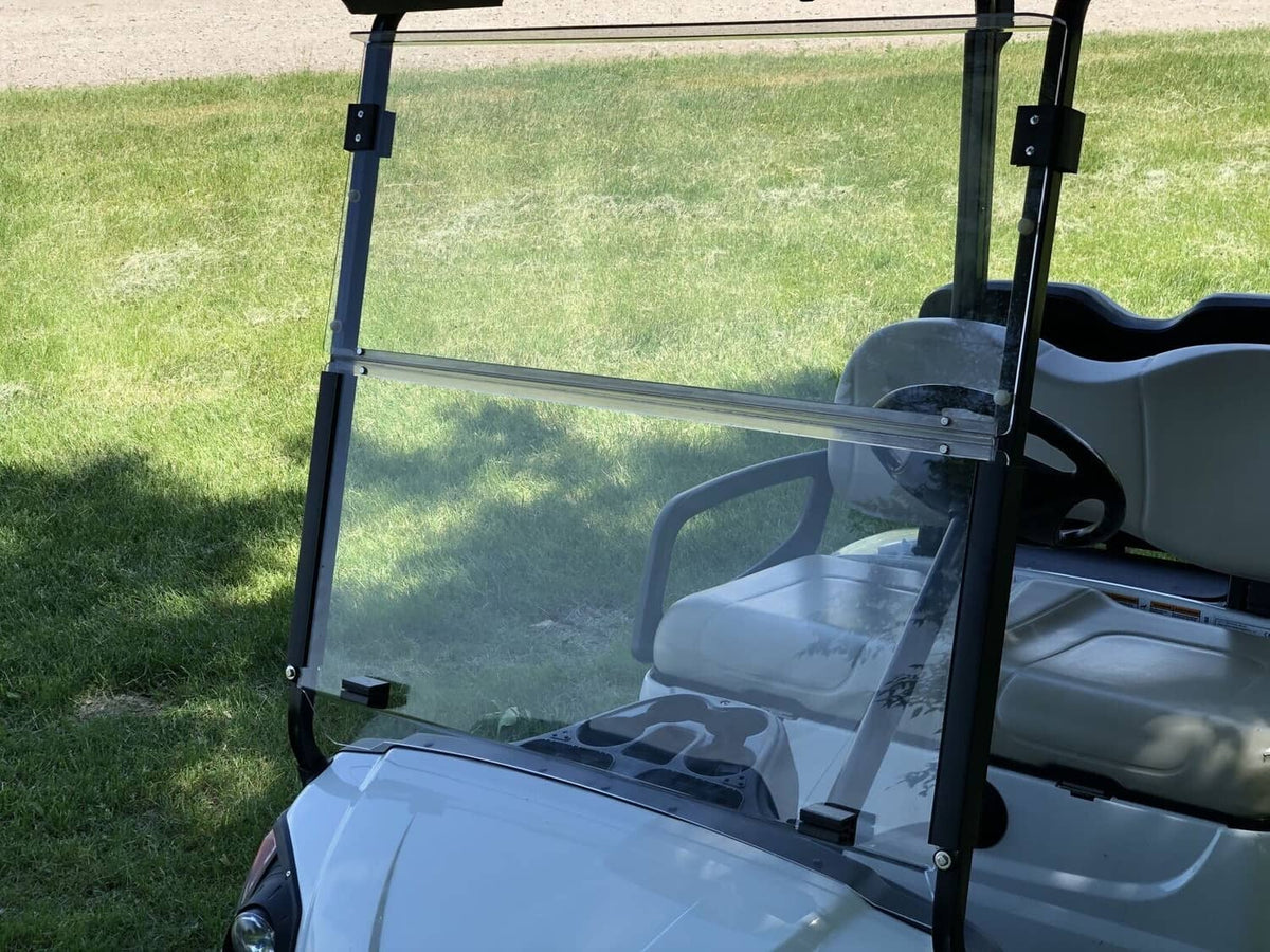 Side view of installed clear windscreen on a golf cart with transparent front panel