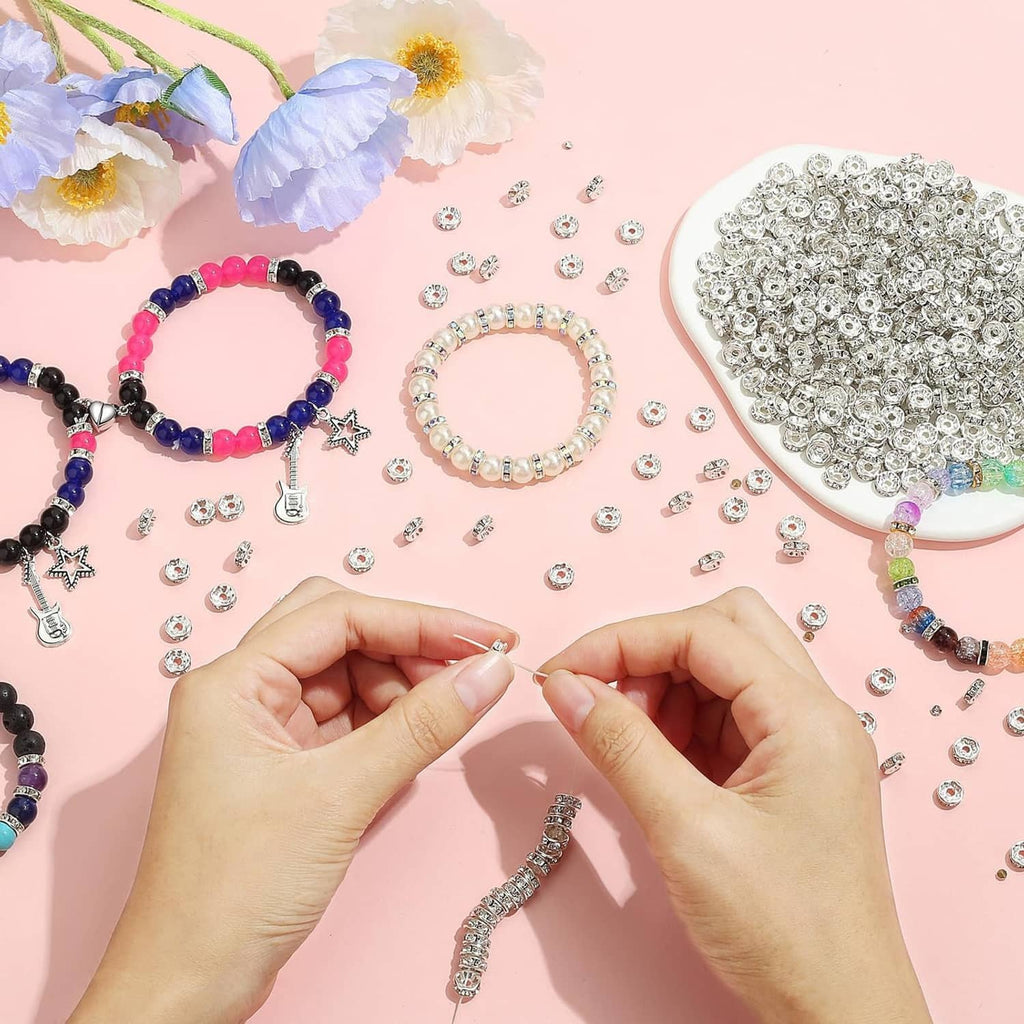 Rhinestone rondelle spacer beads scattered with beaded bracelets and charms