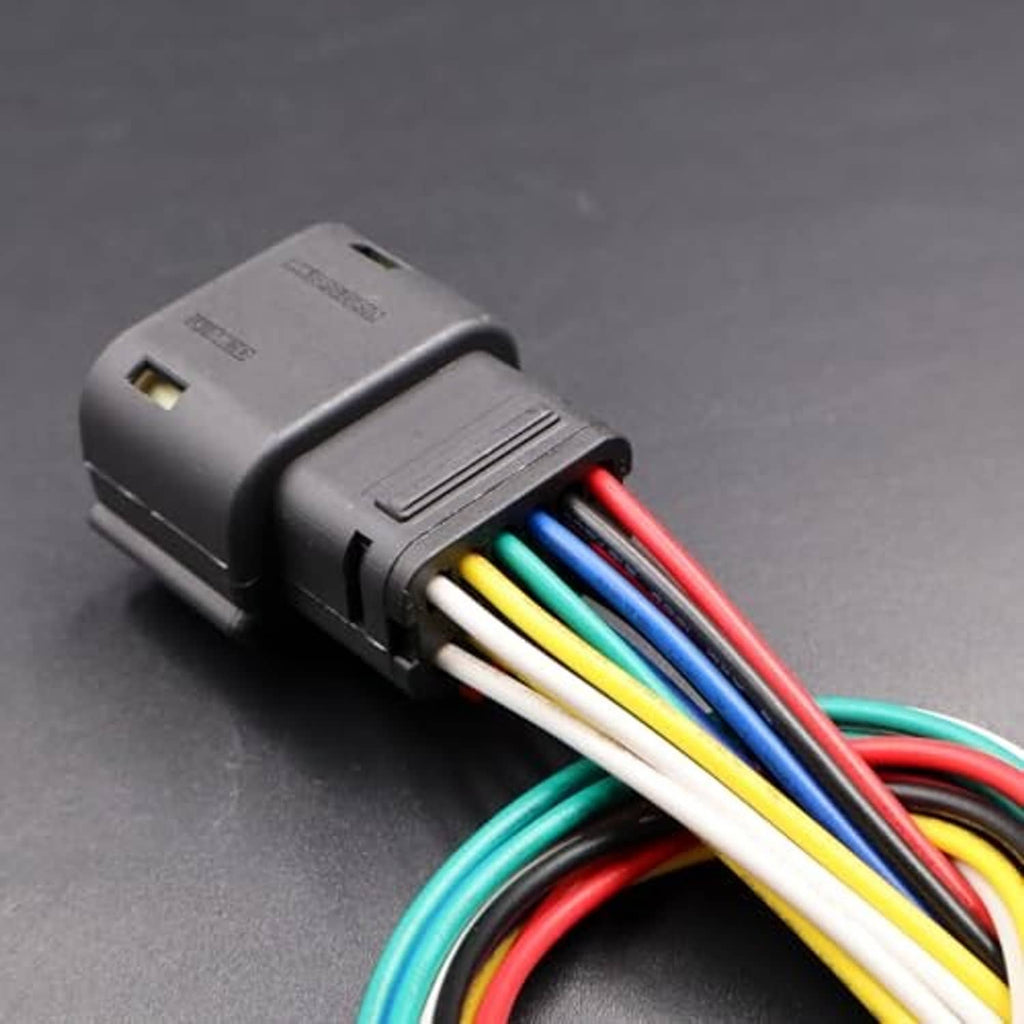 Black electrical connector housing with multi-wire leads, close-up of terminal side
