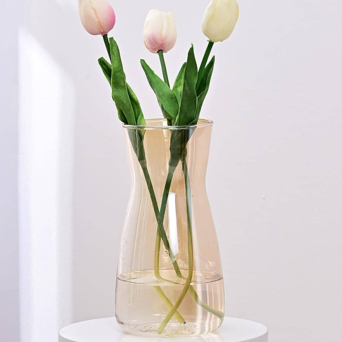 Tall clear glass flower vase with gold iridescent finish, open top holding green stems