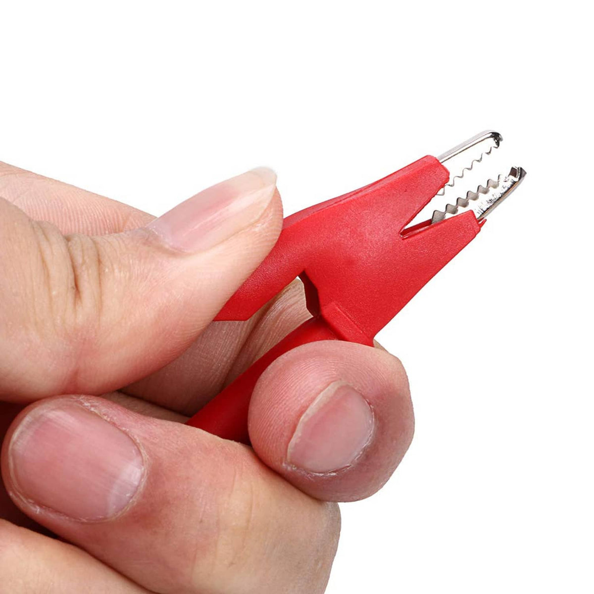 Hand holding a red and black crocodile clip with metal spring contact tips