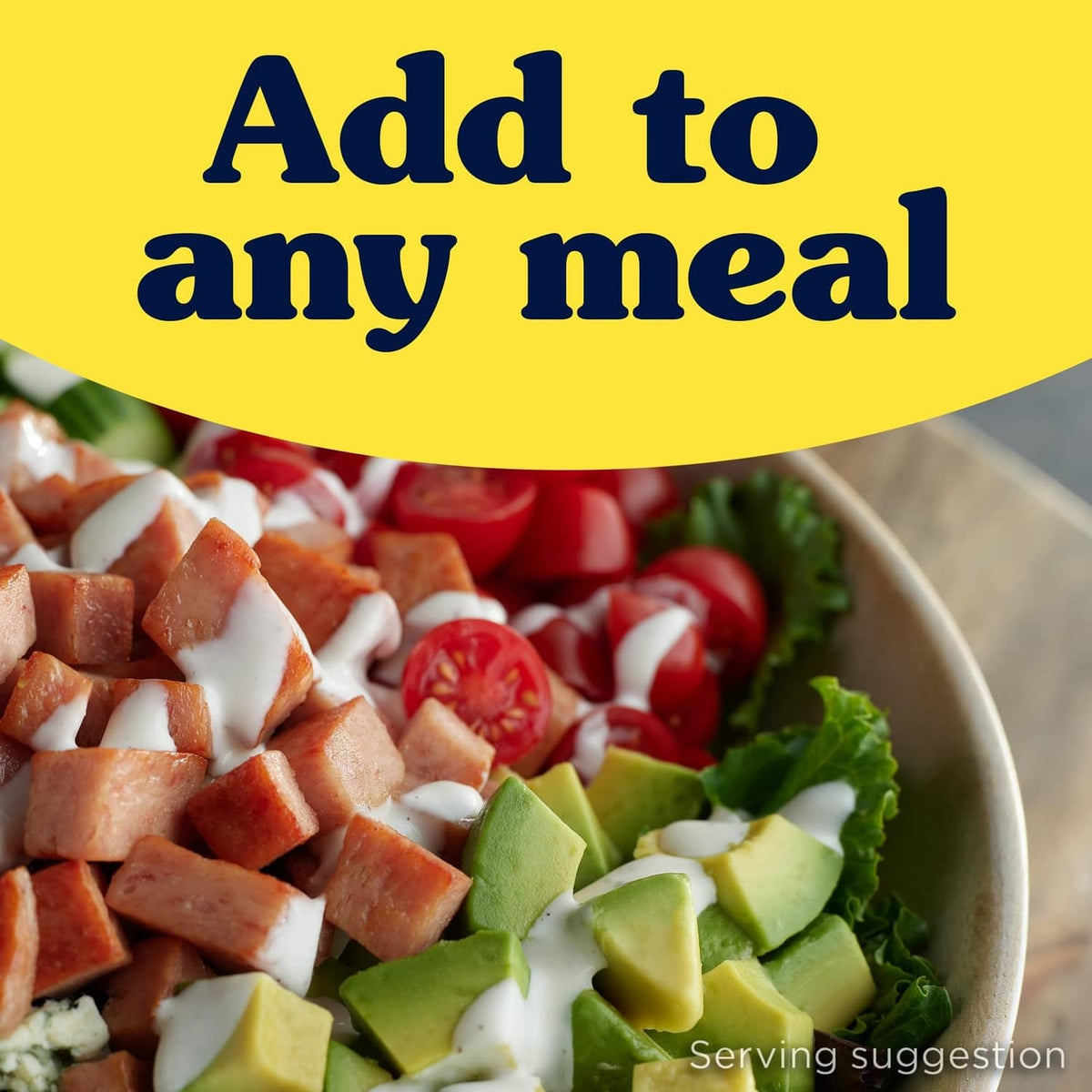 Spam Classic cubes in a salad bowl with vegetables and creamy dressing