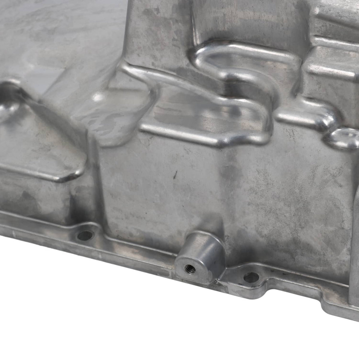 Engine oil pan kit casting close-up with internal ribs, channels, and machined edges