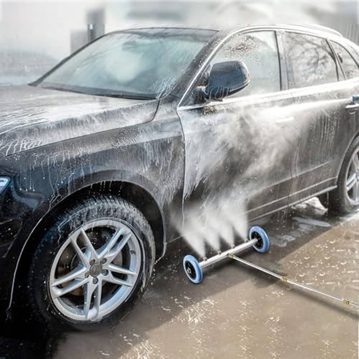 Undercarriage washer wheel and extension wand directing a water spray at car underbody