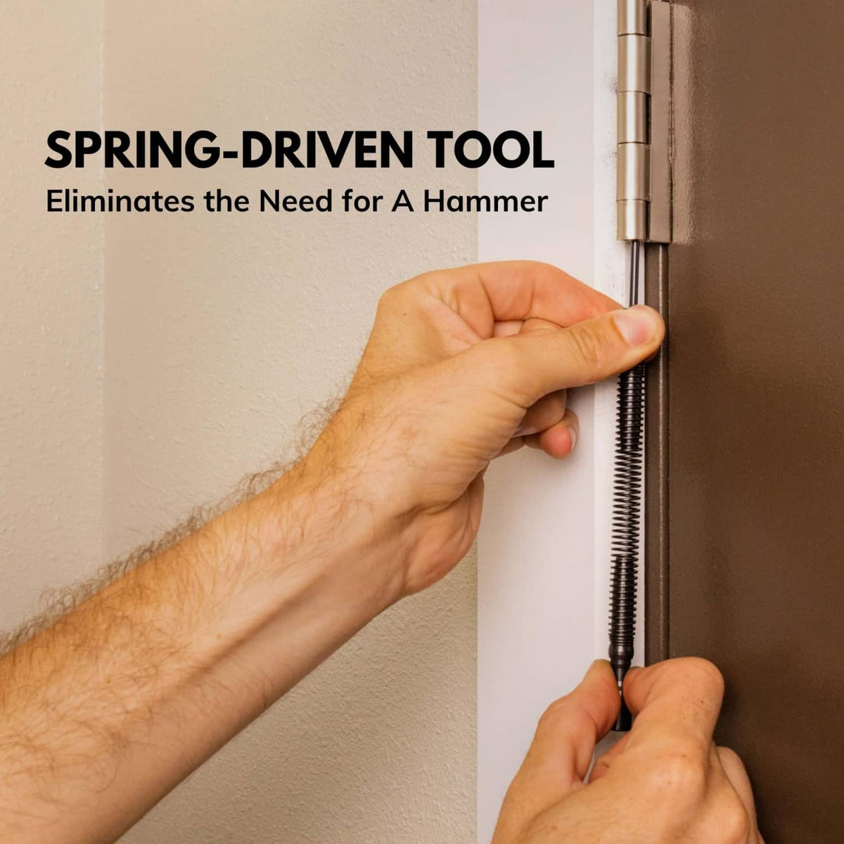 Spring-driven door hinge pin removal tool with black shaft used on hinge pins