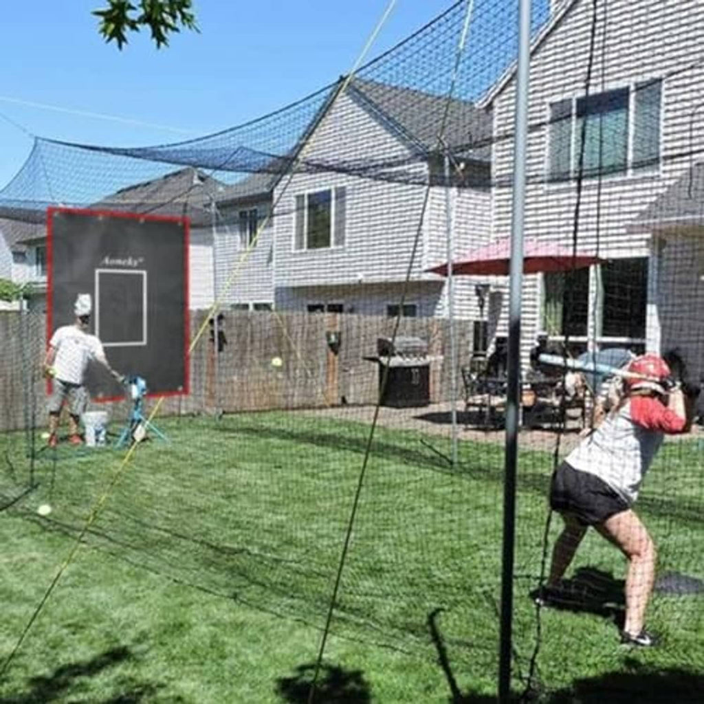 Strike zone training backdrop with red border and white rectangle hanging in backyard yard