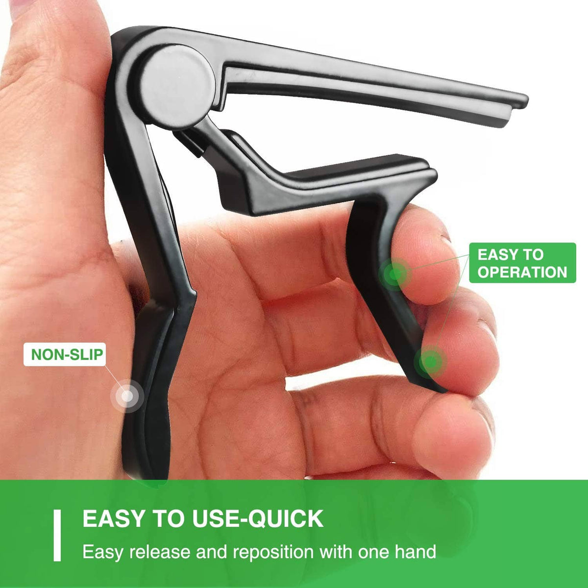 Black guitar capo in hand with non-slip grip and spring clamp head
