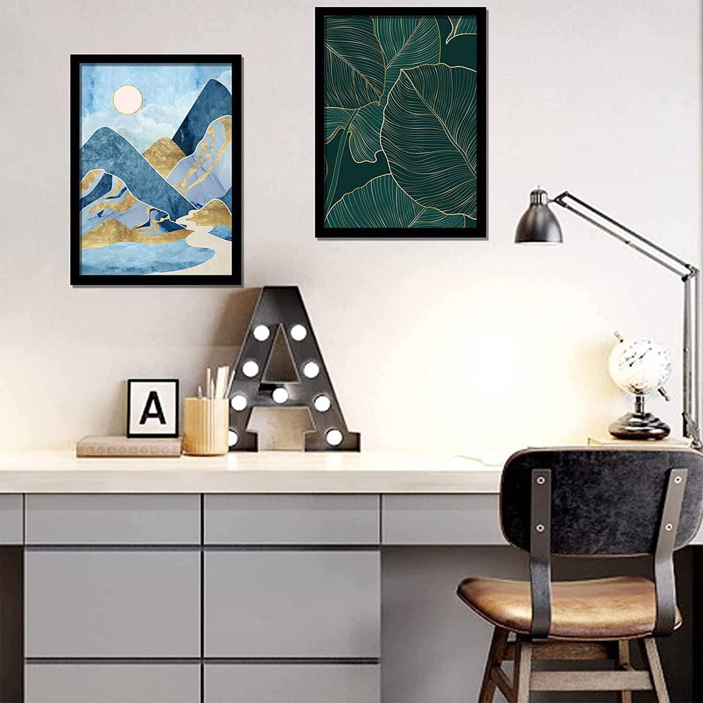 Black picture frame on wall with abstract blue-and-gold print, staged in a room.