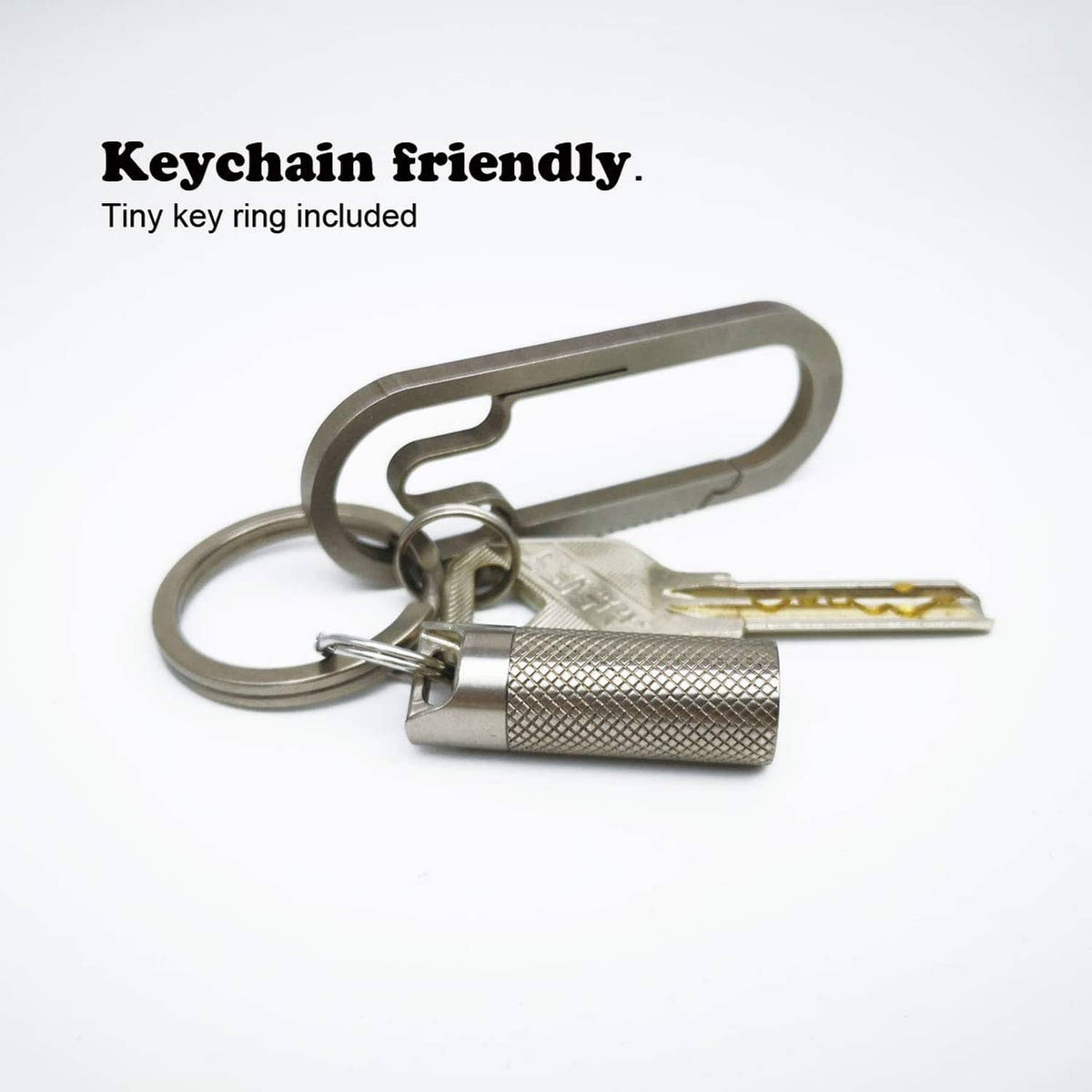 Keychain titanium pill fob with textured cylinder capsule and metal key ring attachment