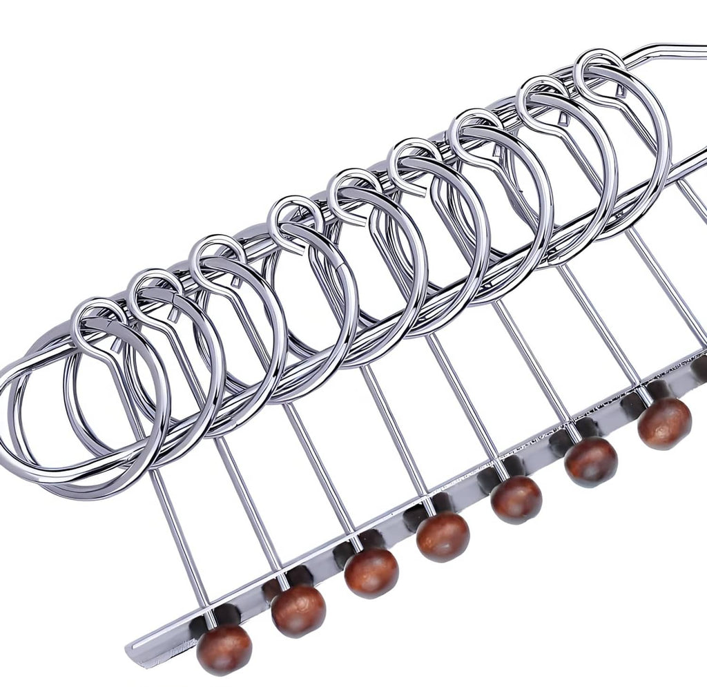 Silver metal linked rings over wire grid with wooden beads, diagonal close-up