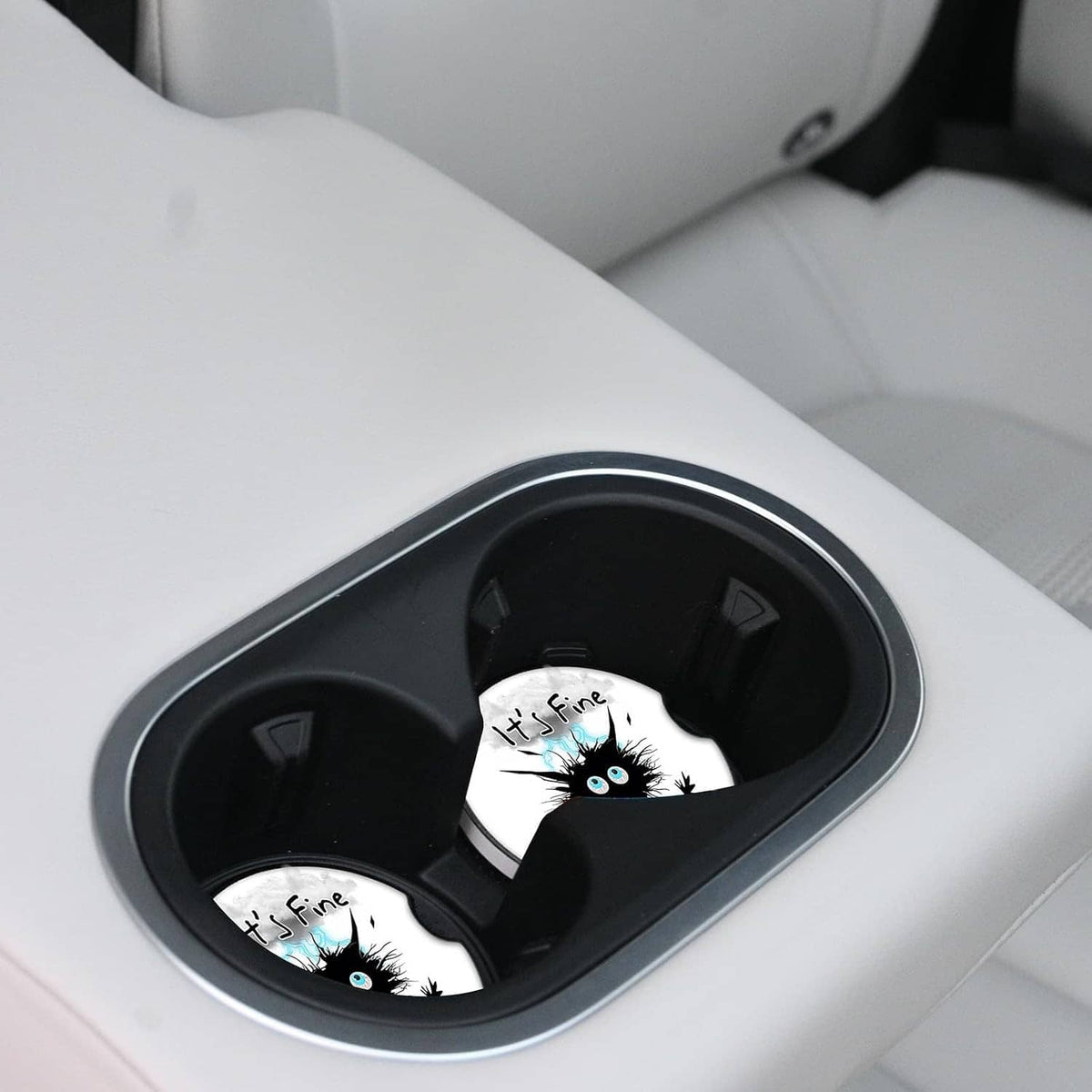Black cat ceramic coaster pair in car cupholder with dark insert surrounds