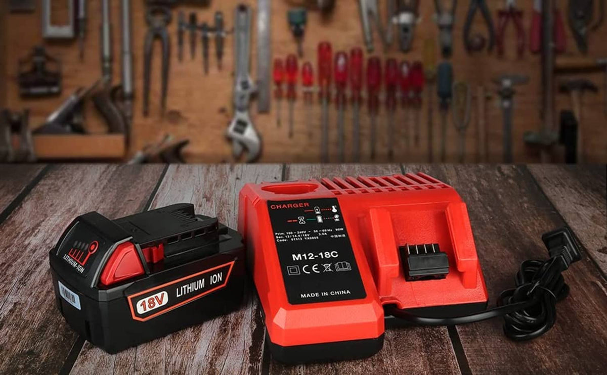 Red charger and black lithium battery pack on a wooden workbench