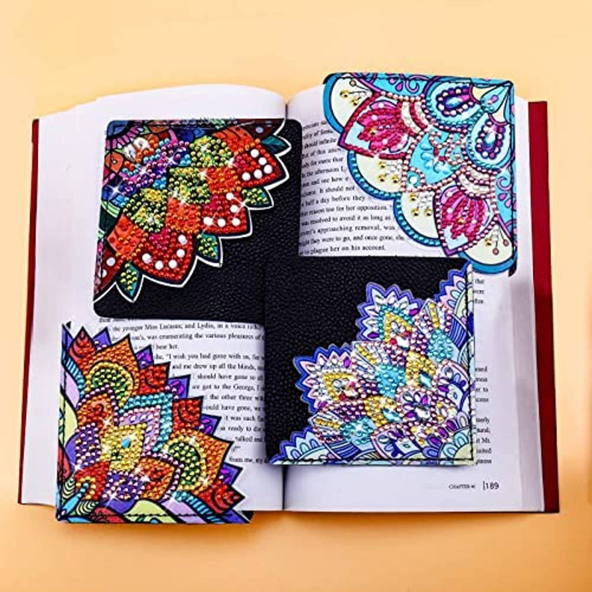 Diamond art bookmarks with colorful mandala designs displayed inside an open book