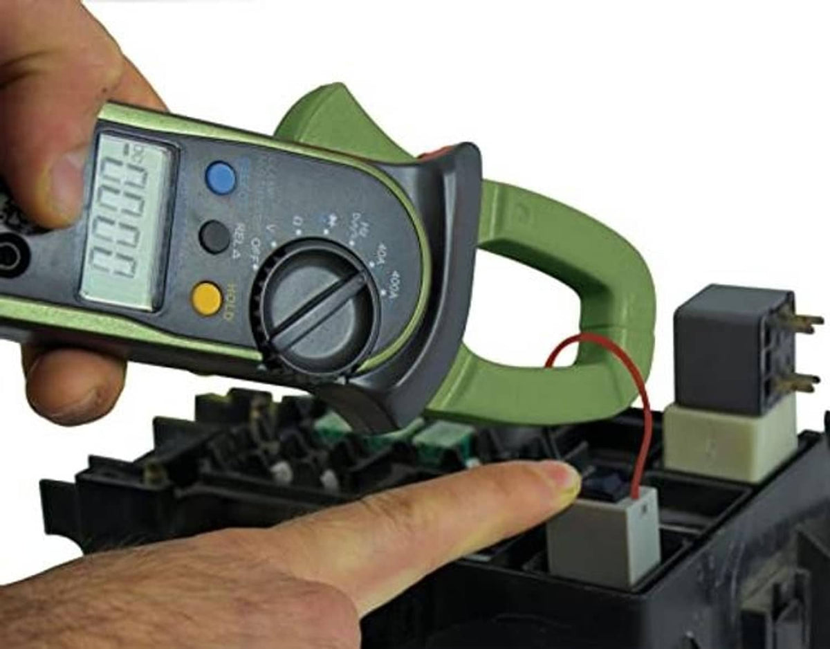 Relay bypass switch module and tester connected on a vehicle fuse/relay panel