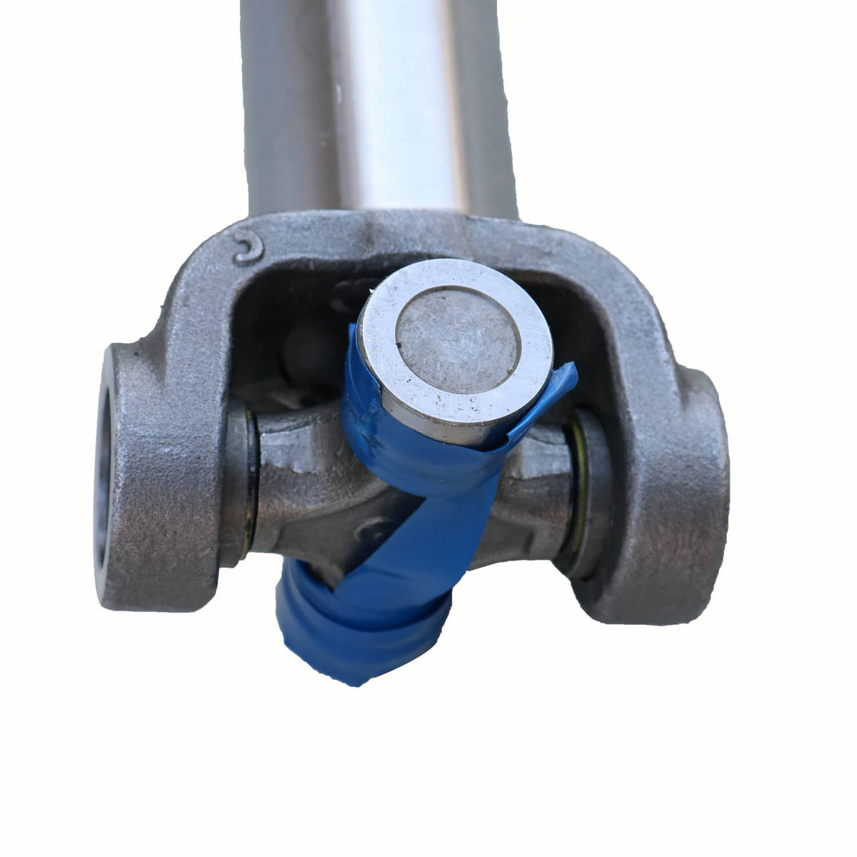 Close-up of front drive shaft universal joint with blue protective boot
