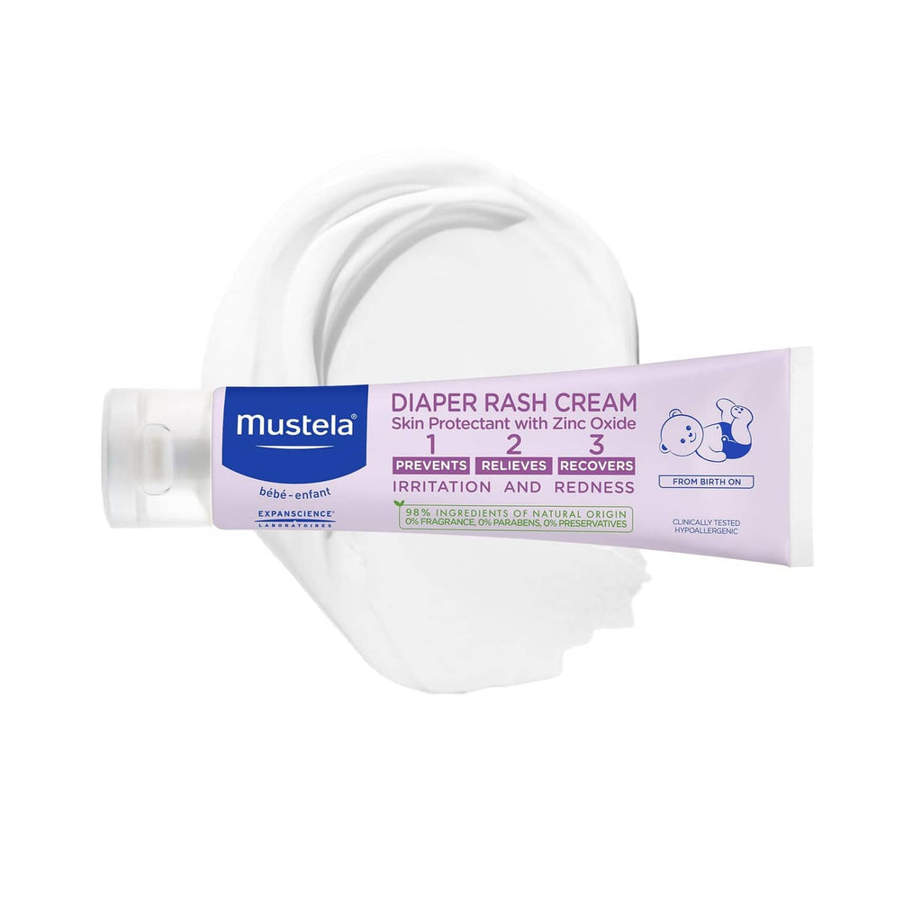 Mustela diaper rash cream tube on white diaper stack