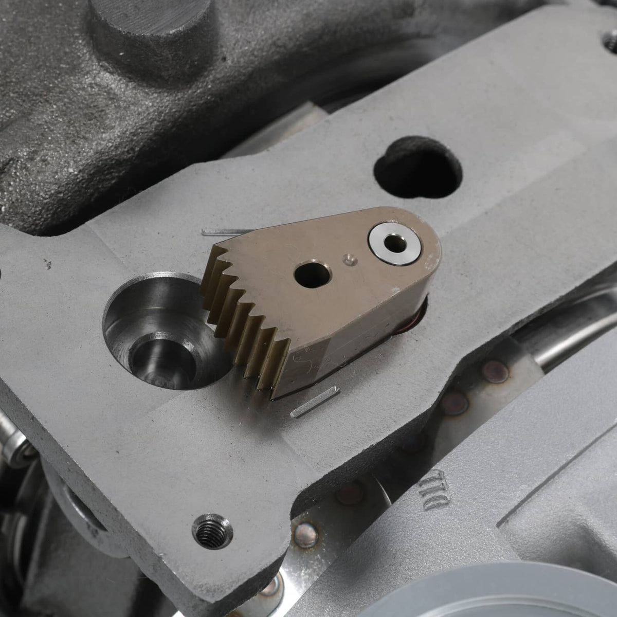 Turbocharger actuator and gear linkage close-up on the housing surface