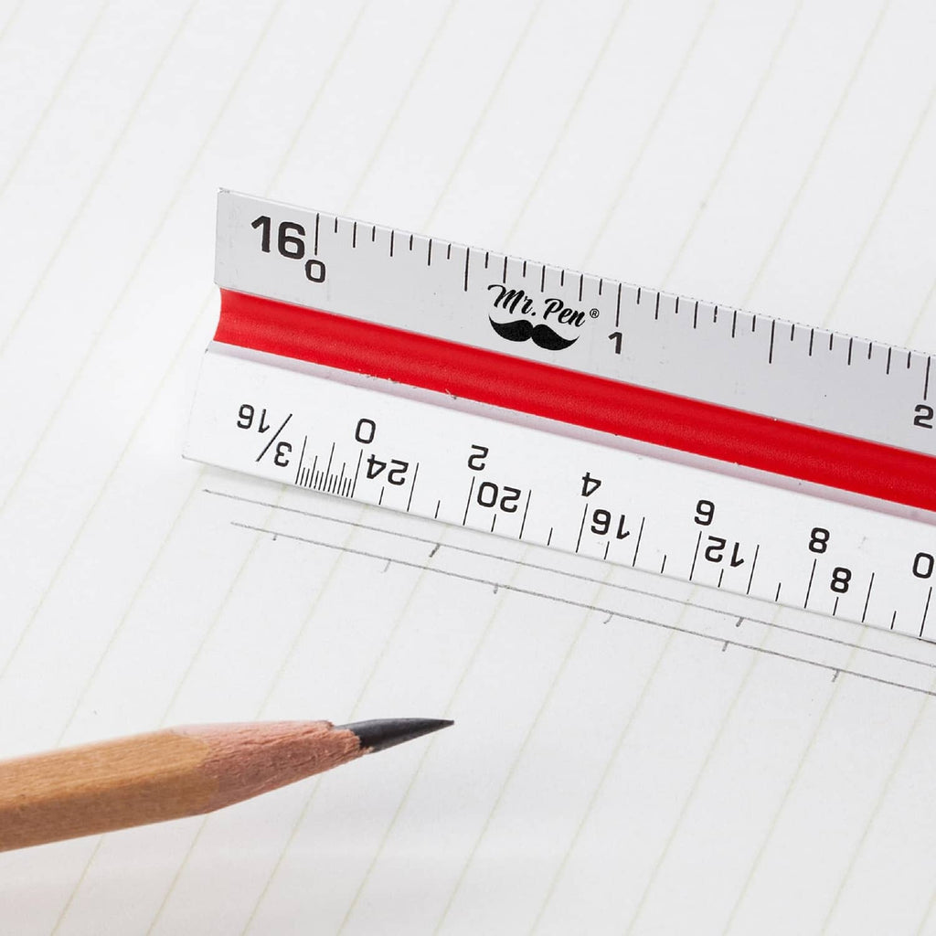Architectural scale ruler with white body and red strip, close-up of etched inch scales