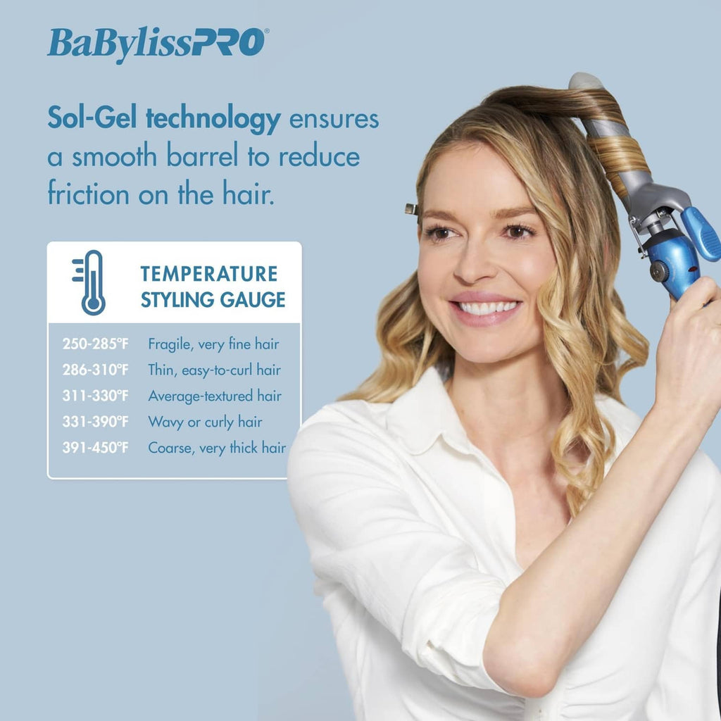 Blue 3/4 in spring curling iron held in hand with silver clamp