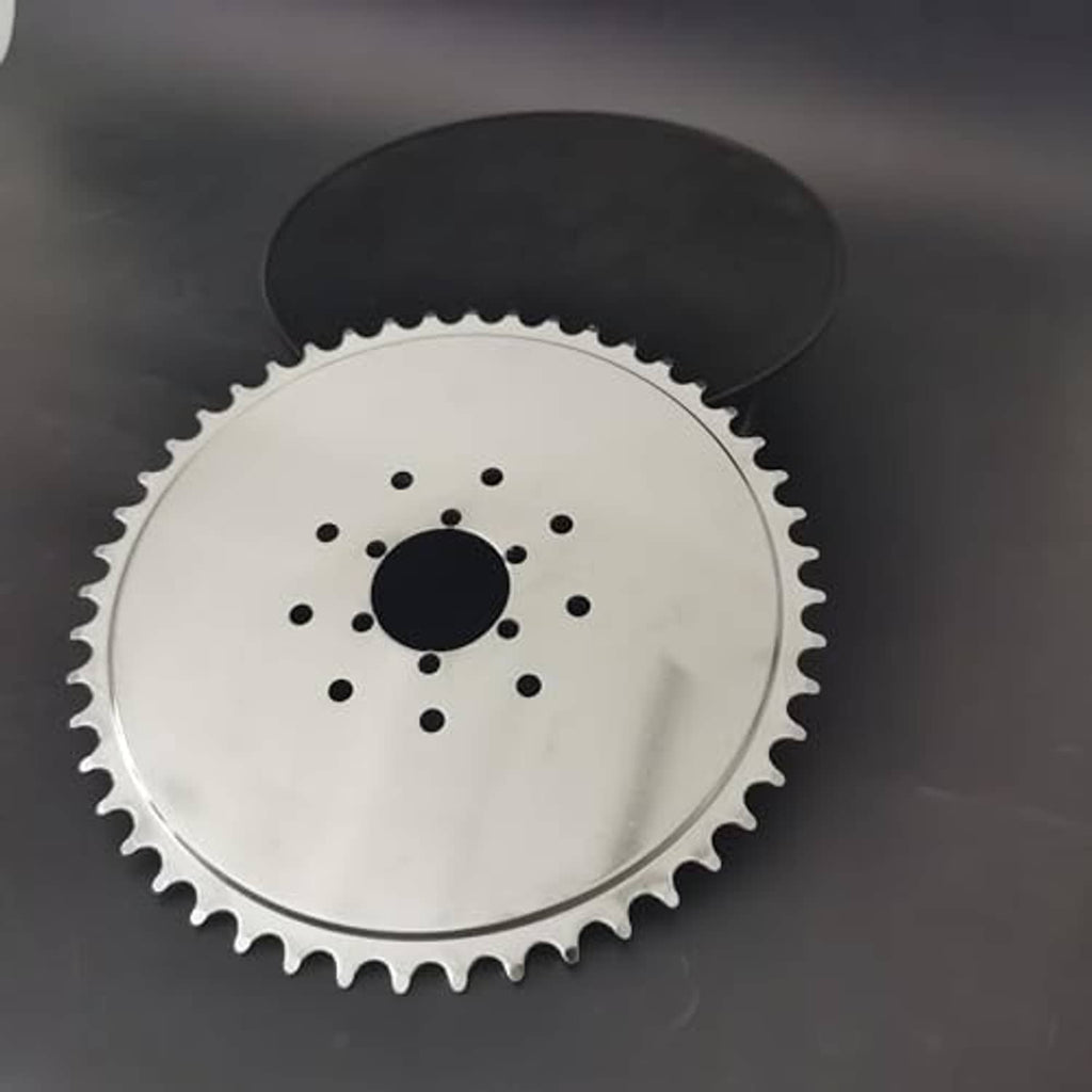 Steel sprocket with black cover plate over the top, showing center bolt holes
