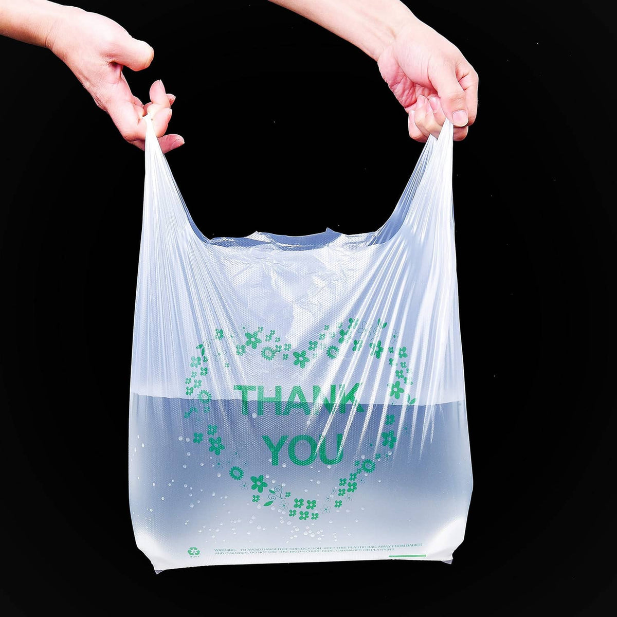 White plastic grocery bag with handles, green THANK YOU clover wreath on front
