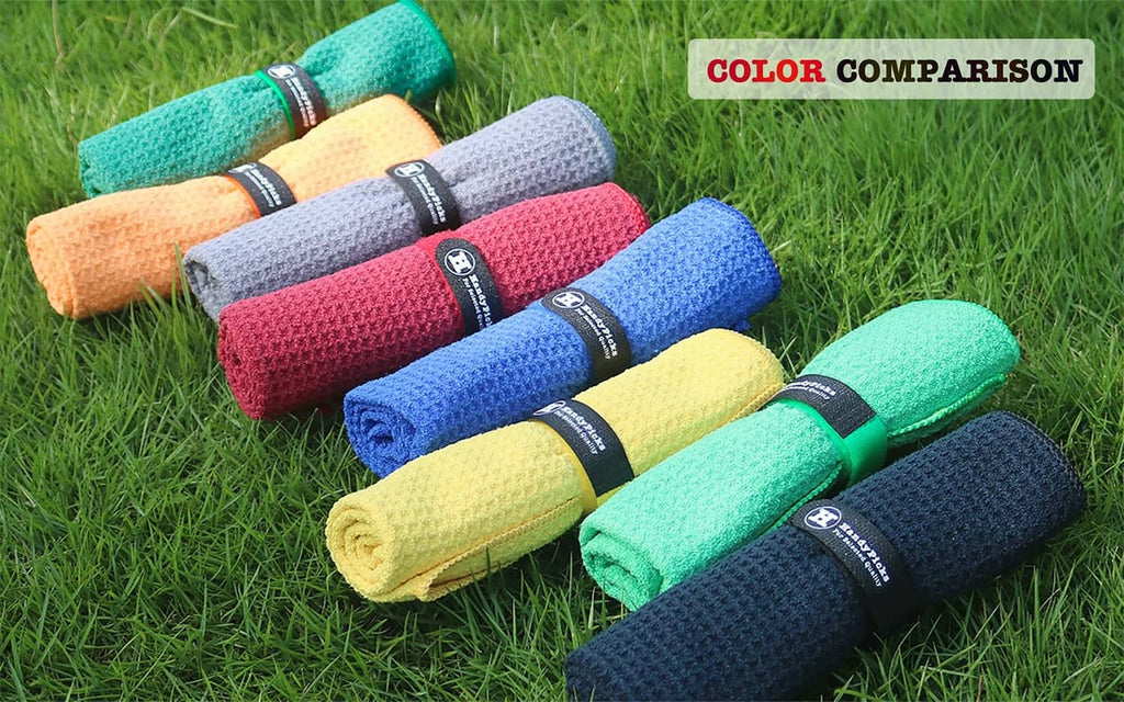 Color comparison of microfiber golf towels in multiple colors on grass