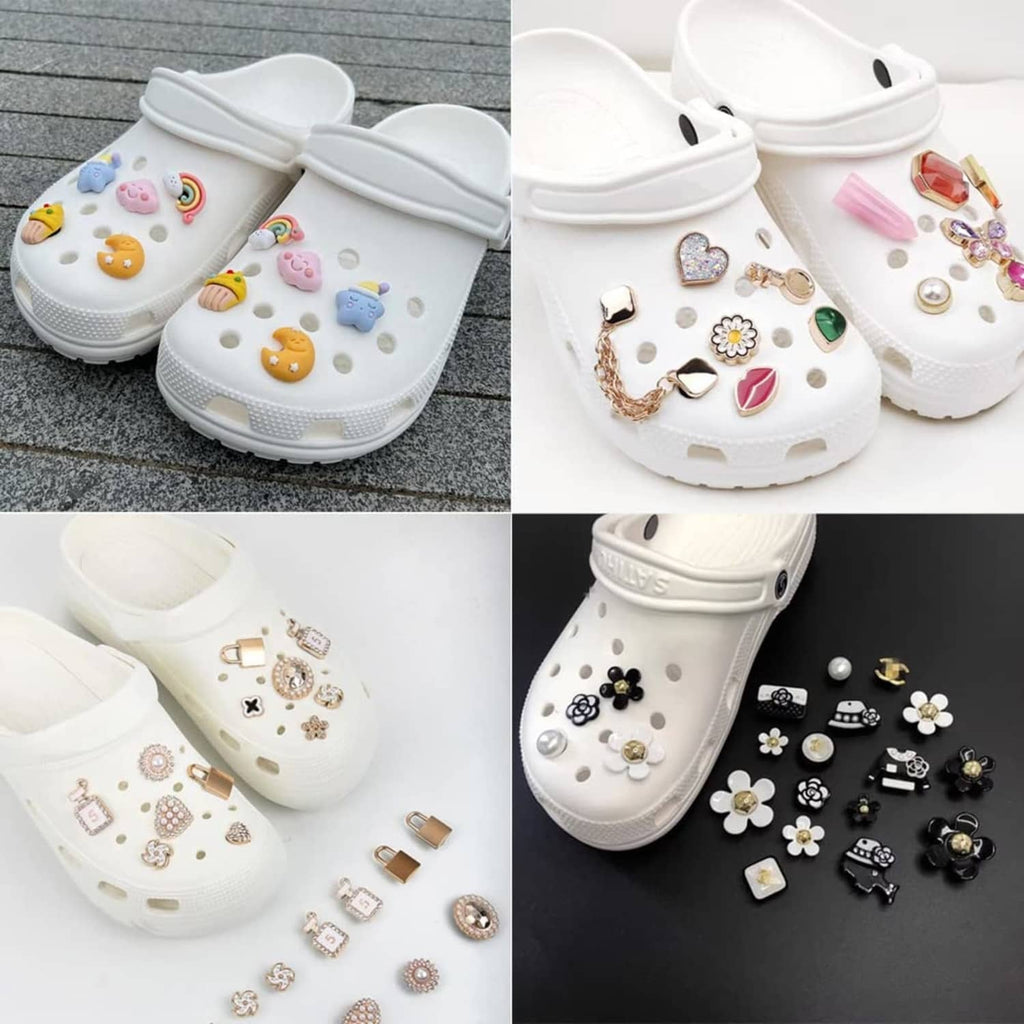 White clogs styled with clear charm button backs and assorted decorative charms